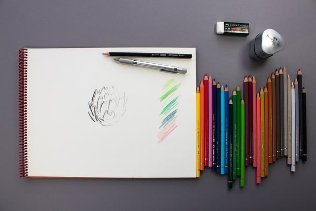 A sketchpad next to color pencils
