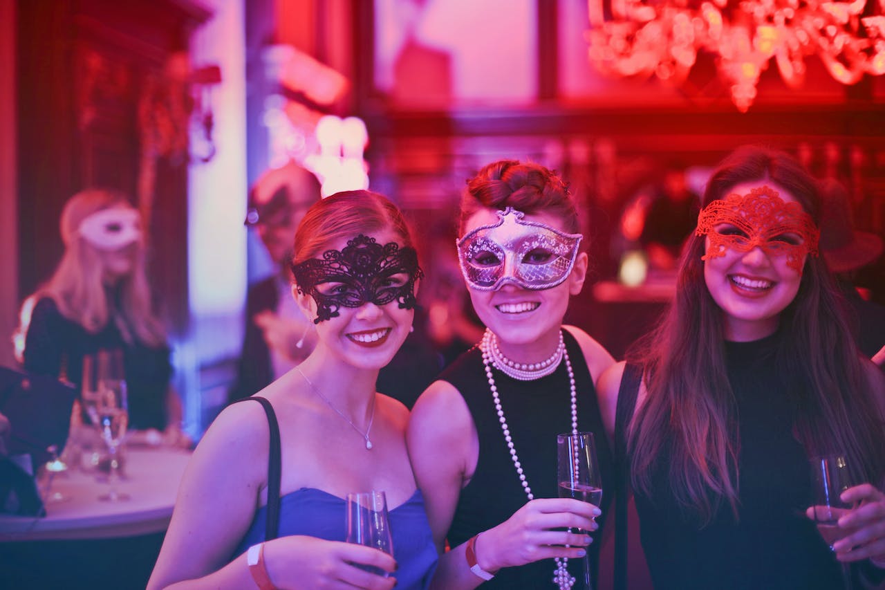 Three women at a masquerade ball